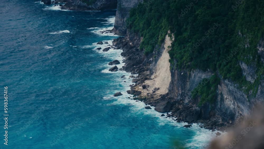 Beautiful dark natural background with cliffs on sea shore and waves rolling on rocky beach. Peaceful summer scene with turquoise ocean and mountains in tropical paradise. Island Generative AI Beautiful dark natural background with cliffs on sea shore and waves rolling on rocky beach. Peaceful summer scene with turquoise ocean and mountains in tropical paradise. Island Generative AI