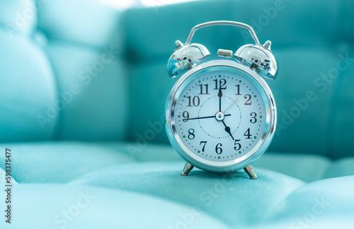 Alarm clock on the sofa with copy space