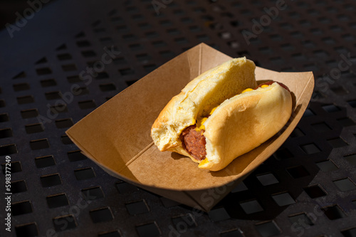 Obraz na plátne Half eaten hotdog on a table