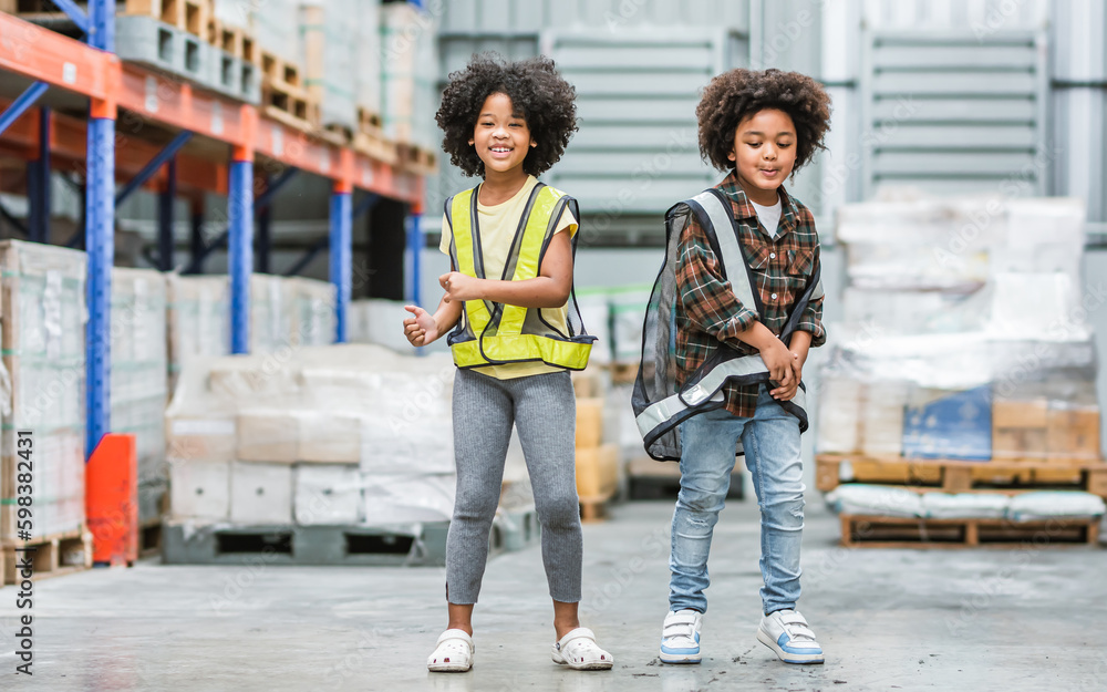 Fototapeta premium Two African little boy, girl kids standing in warehouse, dream to be architect, engineer, worker or business owner, smiling and laughing with happiness with copy space. Education, Career Concept.