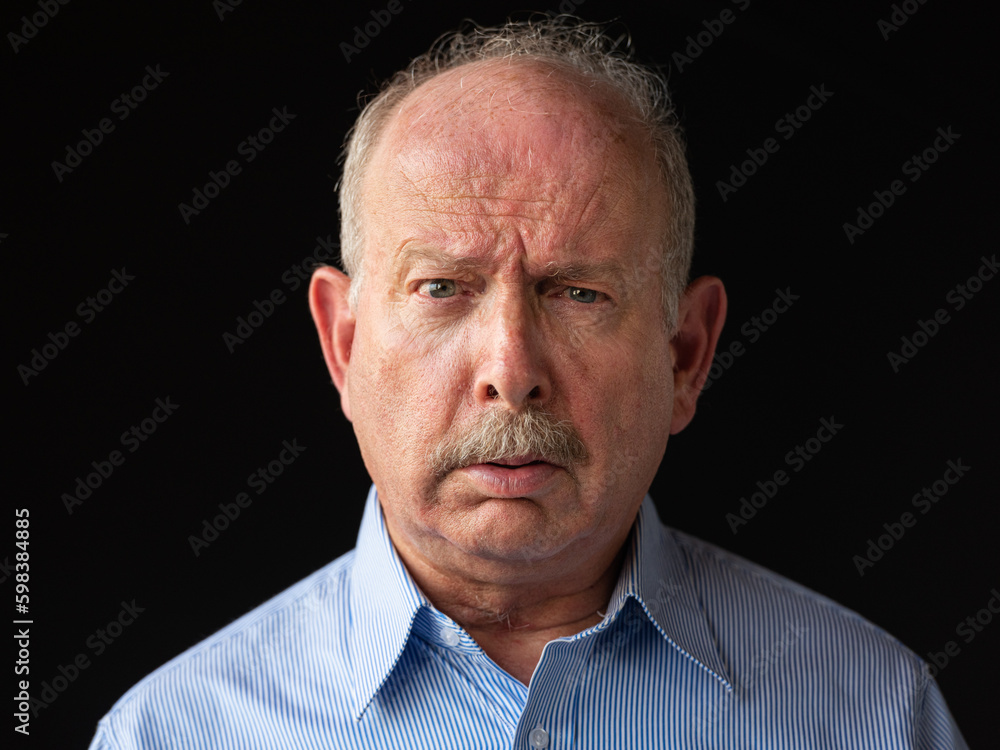 Angry and stressed grey haired senior man with mustache Angry and stressed grey haired senior man with mustache