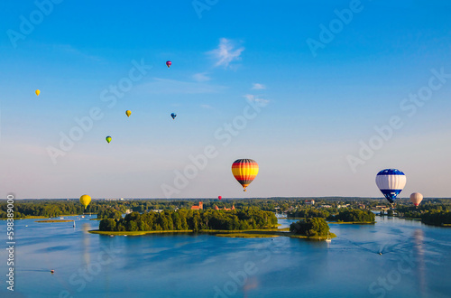 Colorful hot air balloons flying over Trakai Castle photo
