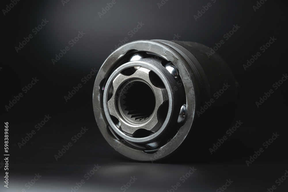 Auto CV joint Connecting the drive shaft on a black background. New hinges of equal angular speeds. New car CV joints. Quality spare parts for car service or repair - obrazy, fototapety, plakaty 
