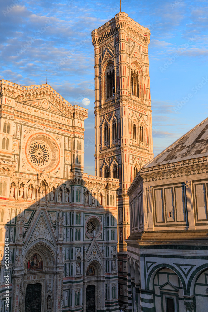 Typical urban view of Florence: the Cathedral of Santa Maria del Fiore with Giotto's Bell Tower and the Baptistery at sunset, Italy.