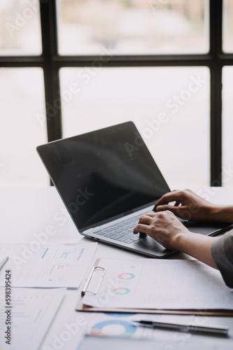 Financial analysts analyze business financial reports on a digital tablet planning investment project during a discussion at a meeting of corporate showing the results of their successful teamwork.