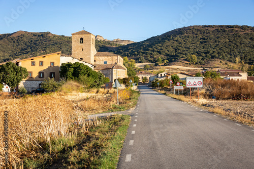 a paved road entering Cascajares de Bureba village, La Bureba, province of Burgos, Castile and Leon, Spain