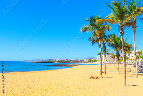 Fototapeta Naklejka Na Ścianę i Meble -  Lonely woman sunbathing on a tropical beach