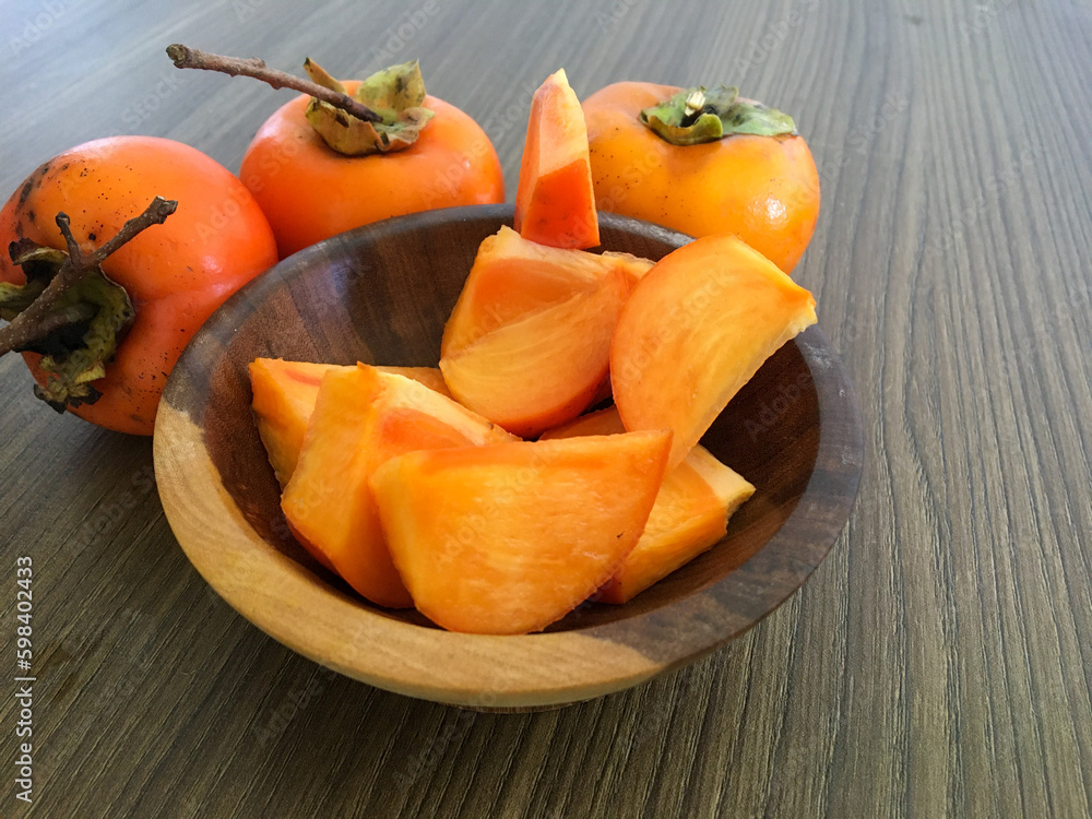 Khaki fruit in the wooden pan