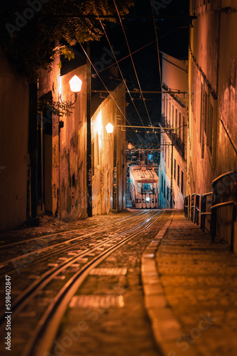 Famous tram of Lisbon in a tight street of the old town at night 