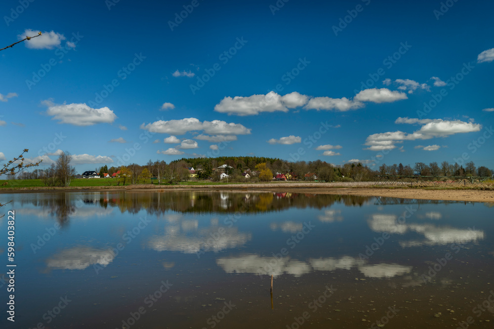 Pond with blue water near Rybnicna village in spring sunny day