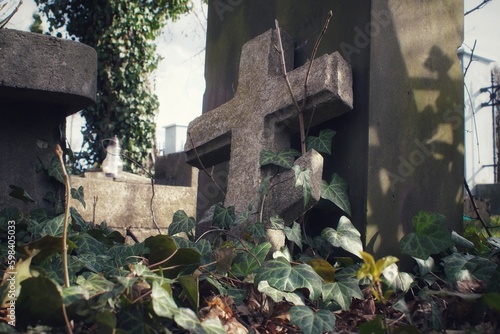 Fotografie A stone cross leaning against a tombstone in the Orthodox cemetery in Plock