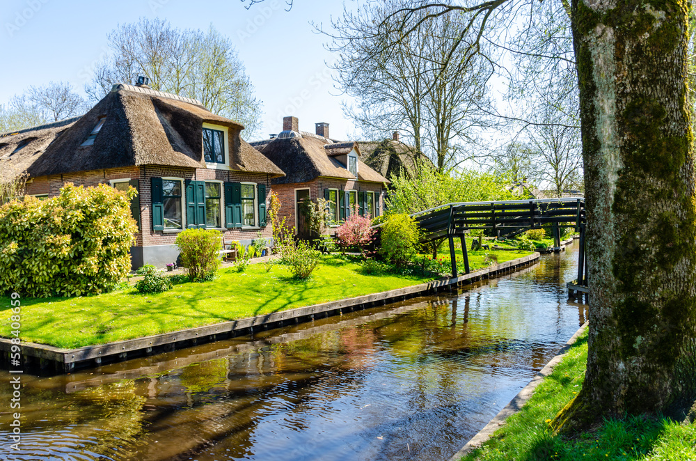 View of typical houses of Giethoorn,The Netherlands.  The beautiful houses and gardening city is know as 