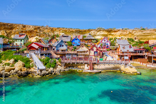 Malta, Il-Mellieha. View of the famous Popeye  village Mellieha and bay on a sunny day photo