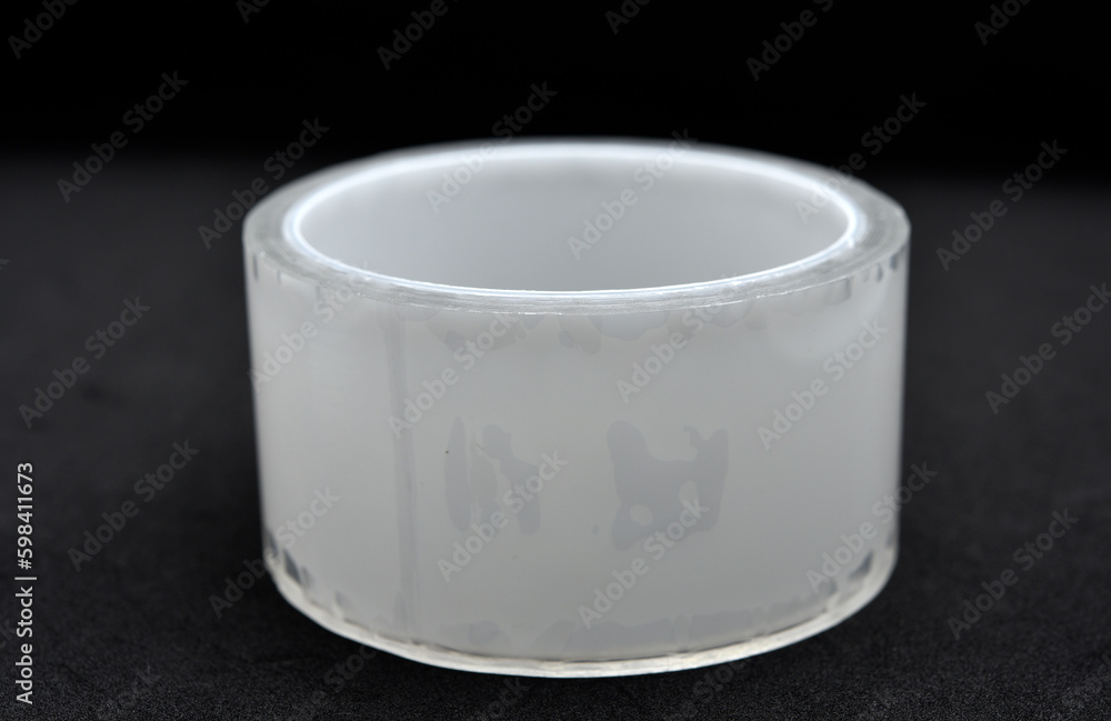 Adhesive tape on a black background. Rolls of transparent tape. Scotch tape on a black background.