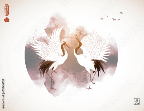 Two dancing japanese red-crowned cranes. Traditional oriental ink painting sumi-e, u-sin, go-hua. Translation of hieroglyph - love