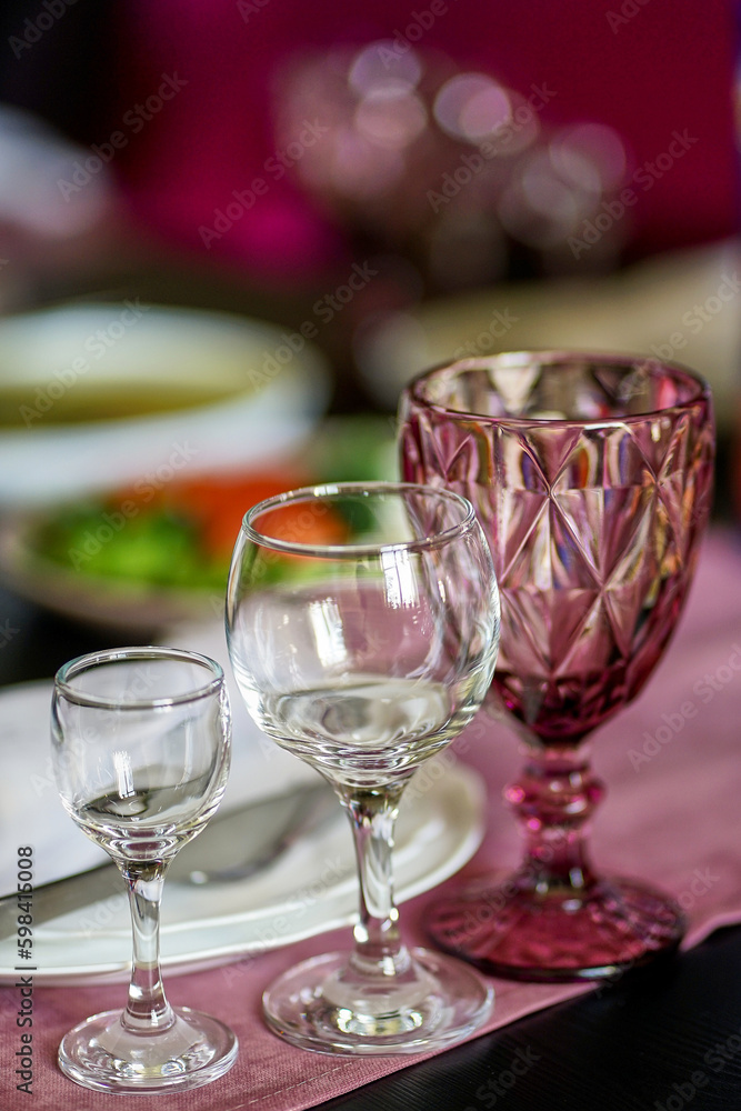 Serving the table with glasses for various drinks. Serving the table with glasses for various drinks.