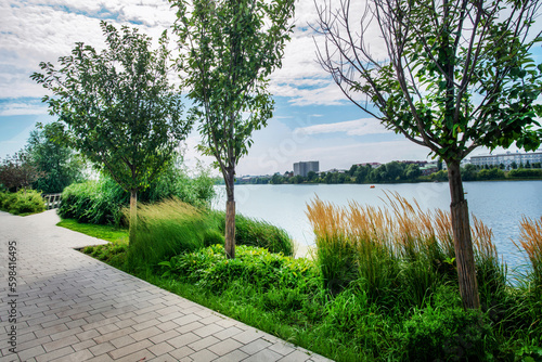 Stone Footpath on bank oа Nizhny Kaban Lake and amazing garden