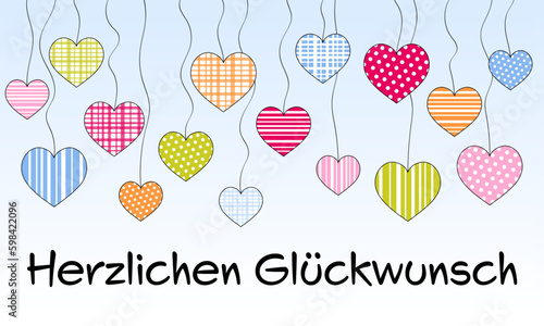 Herzlichen Glückwunsch - Schriftzug in deutscher Sprache. Gratulationskarte mit einem Himmel voller bunter Herzen.