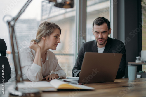Wallpaper Mural Teamwork in business. Partners are discussing business issues at the table in the office. Torontodigital.ca