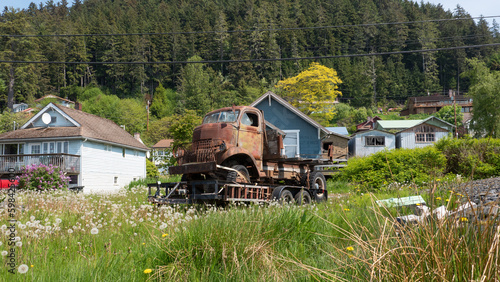 Corroded truck in village. Old abandoned truck covered in rust. Rusty truck outdoors