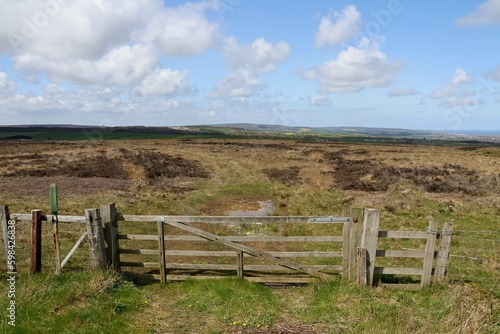 Wooden gate against an open moor 