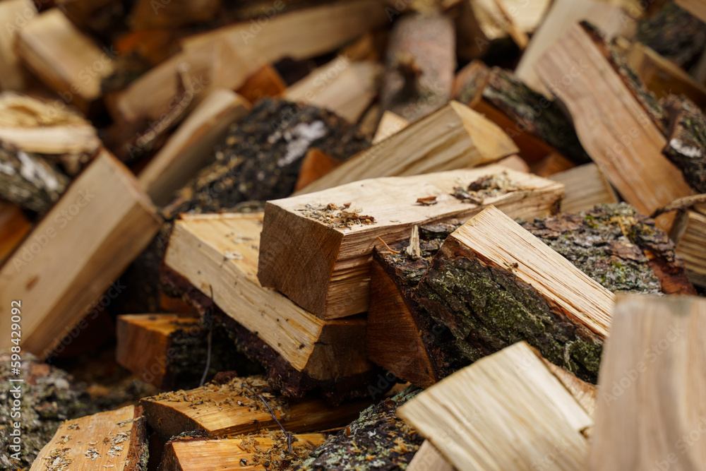 Dry chopped firewood in a pile. Abstraction and background Dry chopped firewood in a pile. Abstraction and background