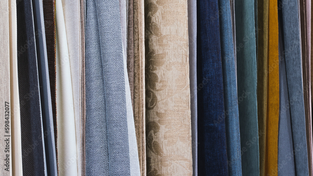 Mix colorful hanging vertical stripe textile, fabrics, cloths on the rack. Texture of multicolored fabrics close up. Mix colorful hanging vertical stripe textile, fabrics, cloths on the rack. Texture of multicolored fabrics close up.
