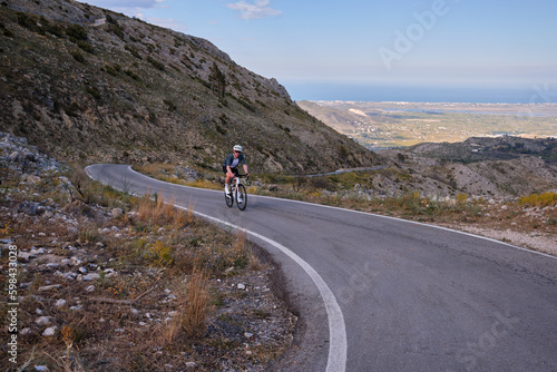 Fit male cyclist is raining for competition.Sportsmen training hard on bicycle outdoors.Sport motivation.Pego,Spain