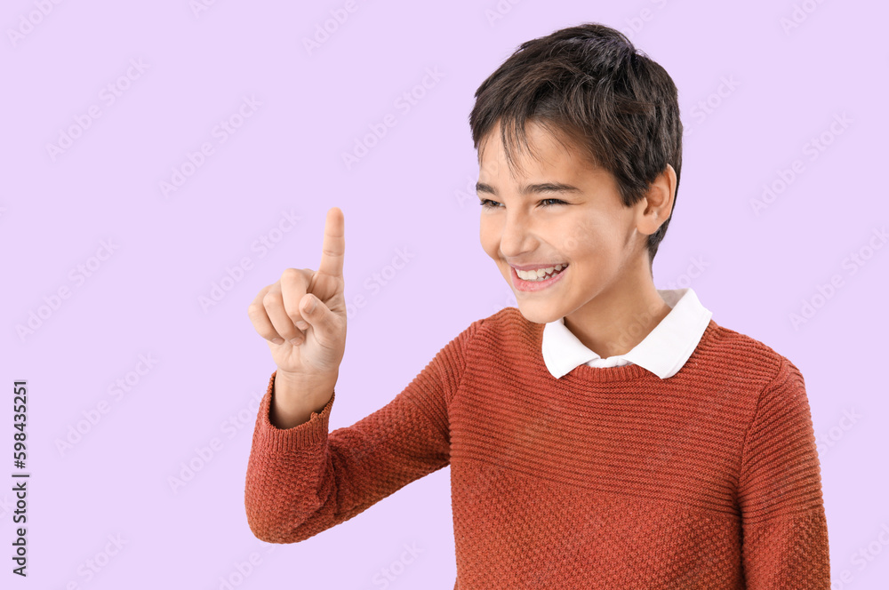 Little boy using virtual screen on lilac background Little boy using virtual screen on lilac background