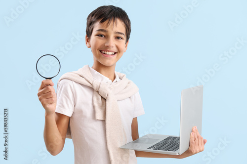 Little boy with magnifier a...
