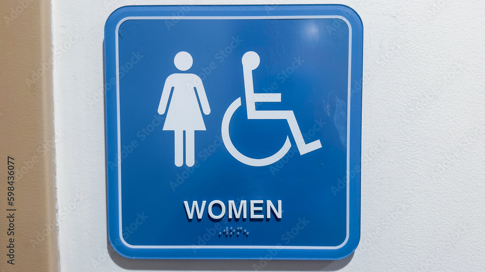 Restroom sign with figures of a girl, guy, and handicap symbol depicts