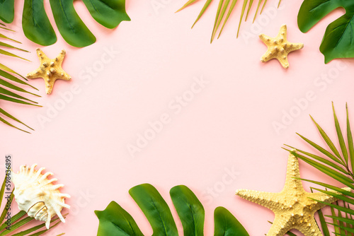 Summer flat lay background. Tropical leaves, palm leaves and sea shells on white background.
