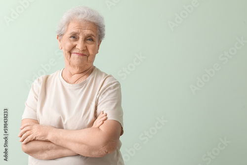 Senior woman on green backg...