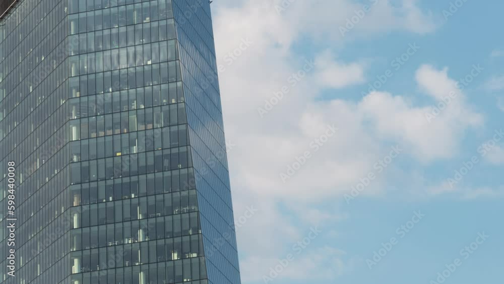 Timelapse high rise glass skyscraper office building facade, moving blue sky and clouds, windows glass structure. Time lapse downtown financial district, daylight, cloudscape, heaven Timelapse high rise glass skyscraper office building facade, moving blue sky and clouds, windows glass structure. Time lapse downtown financial district, daylight, cloudscape, heaven
