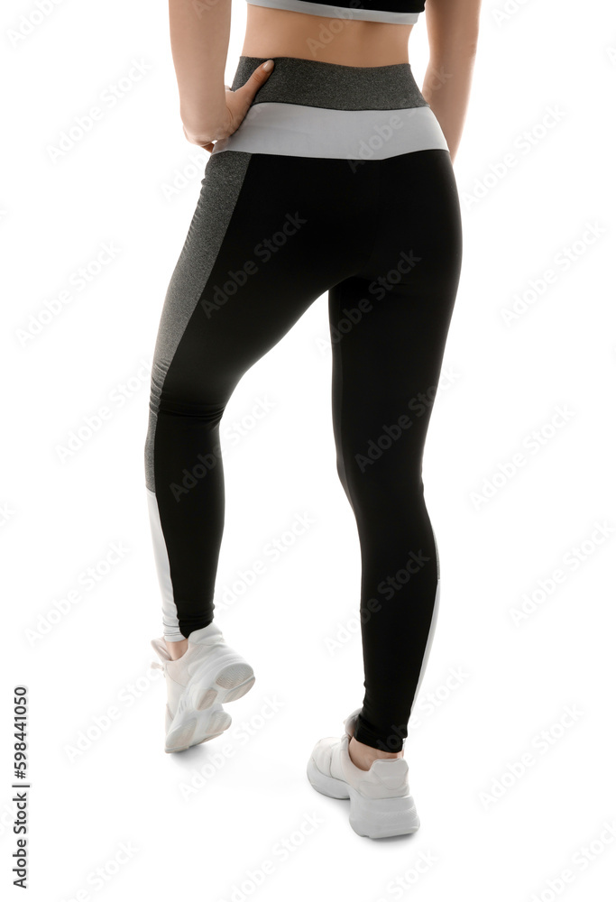 Sporty young woman in leggings on white background