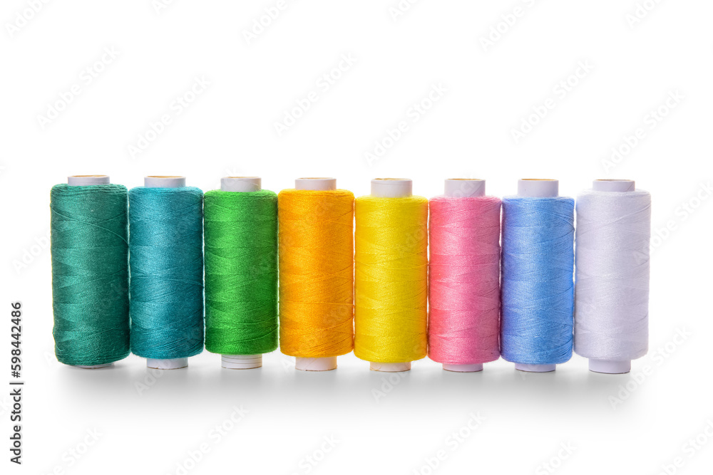 Set of colorful thread spools on white background Set of colorful thread spools on white background