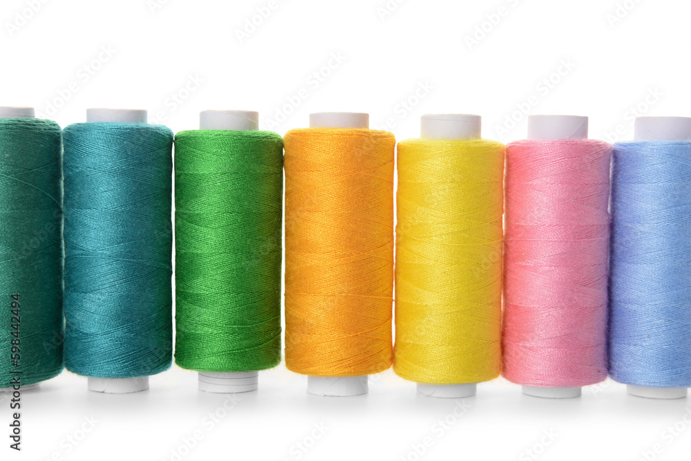 Set of colorful thread spools on white background, closeup Set of colorful thread spools on white background, closeup