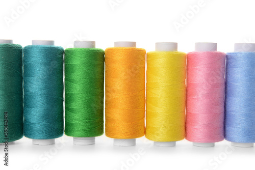 Set of colorful thread spools on white background, closeup