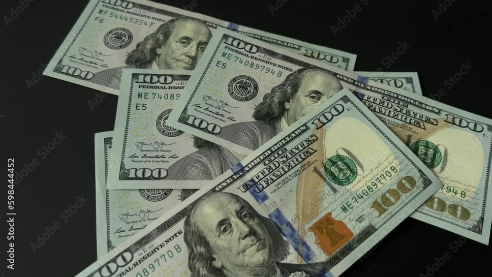 Many dollars counting money. Dollars falling on the table. 100 dollar bills Many dollars counting money. Dollars falling on the table. 100 dollar bills