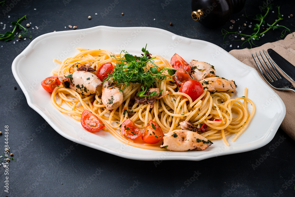 Lunch pasta with squid, octopus, cherry tomatoes and herbs. Lunch pasta with squid, octopus, cherry tomatoes and herbs.
