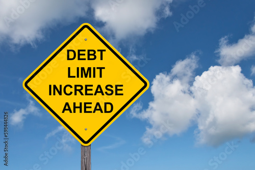 Debt Limit Increase Ahead Caution Sign - Blue Sky Background photo