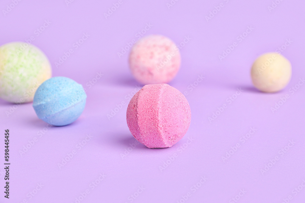 Bath bombs on lilac background, closeup Bath bombs on lilac background, closeup