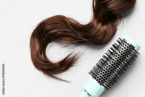 Brown hair with round brush on white background