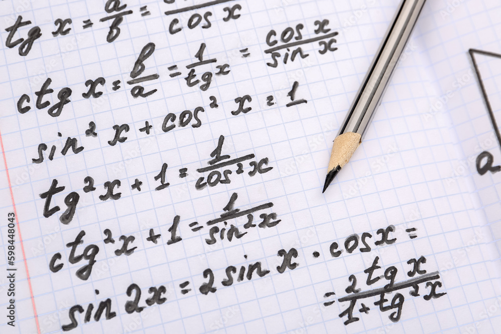 Copybook with maths formulas and pencil, closeup Copybook with maths formulas and pencil, closeup