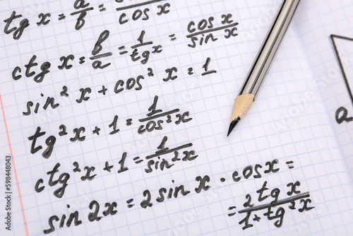 Copybook with maths formulas and pencil  closeup