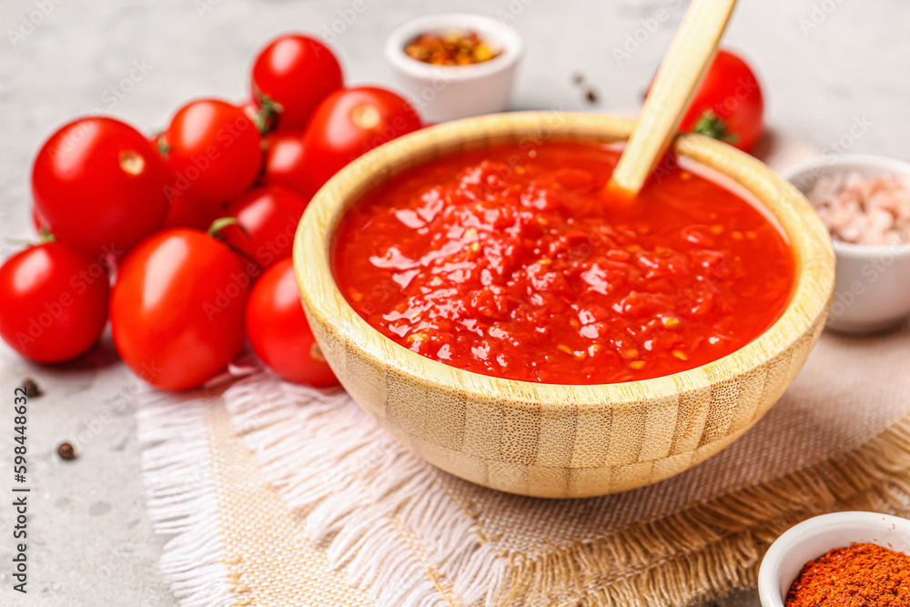 Bowl with tasty tomato sauce on table, closeup Bowl with tasty tomato sauce on table, closeup
