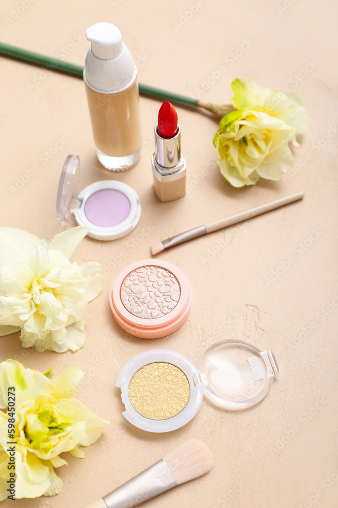 Beautiful daffodils with different cosmetics on beige background