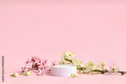 Fototapeta Naklejka Na Ścianę i Meble -  Decorative podium and blooming branches on pink background