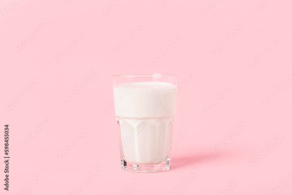 Glass of milk on pink background Glass of milk on pink background