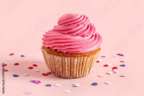 Pink frosted cupcake with b...